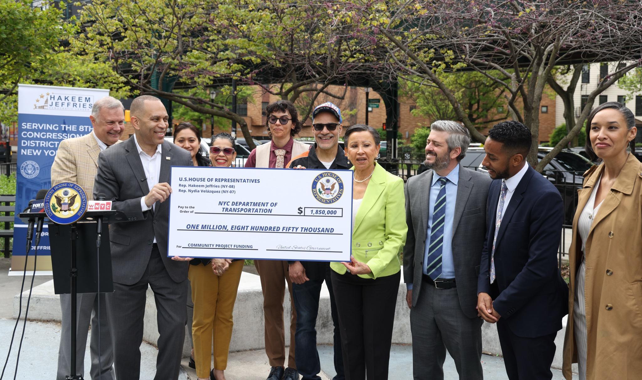 House Democratic Leader Hakeem Jeffries and Rep. Nydia Velazquez hold a ceremonial check in a ceremony with other officials, including (not in order) Borough President Antonio Reynoso, City Councilmember Sandy Nurse, NYC Department of Transportation Commissioner Mike Flynn, Community Board 4 District Manager Celeste León and others. Photo: Rep. Jeffries' Office