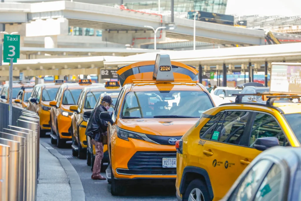 Taxi drivers wait to pick up travelers at JFK airport, June 9, 2026. Credit: Alex Krales/The City Reporter