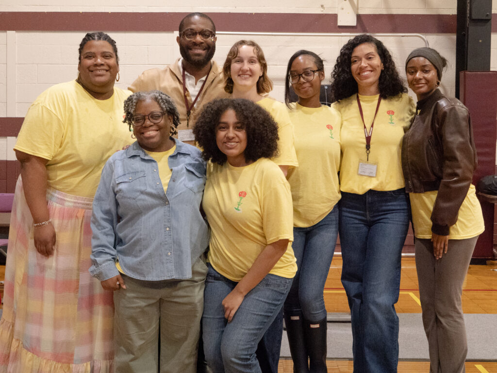 Members of NewComm’s staff, including founder and CEO Chidi Osaluka, top row, second from left, and program alum and Lead Peer Mentor Bianca Estrada, front row, center. Photo: NewComm
