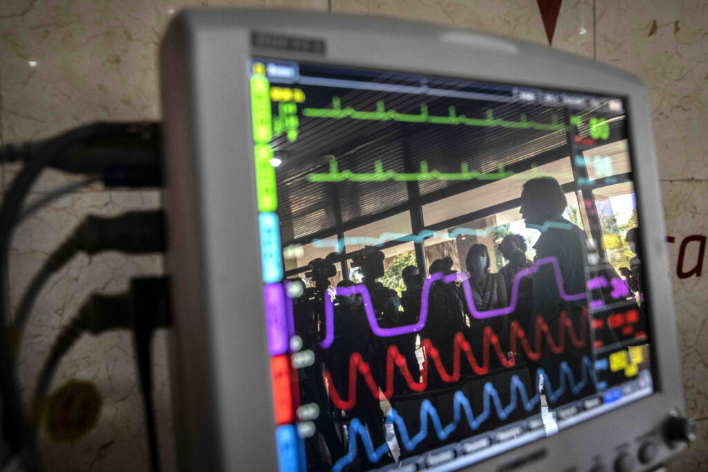 Reflections are shown on the screen of a heart monitor. Photo: Ramon Espinosa/AP