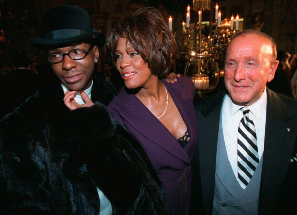 FILE - Bobby Brown, left, and Whitney Houston appear with music producer Clive Davis, right, at a pre-Grammy party in New York on Feb. 24, 1998. (AP Photo/Stuart Ramson, File)