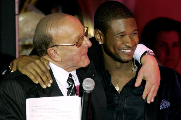 FILE - Clive Davis, left, and Usher appear at Davis' 2005 pre Grammy party in Beverly Hills, Calif. on Feb. 12, 2005. (AP Photo/Chris Polk, File)