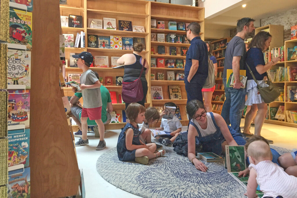 Customers appear in the children's area of the Books Are Magic bookstore, owned by author Emma Straub, in Brooklyn, on April 29, 2017. Photo: Beth J. Harpaz/AP, File