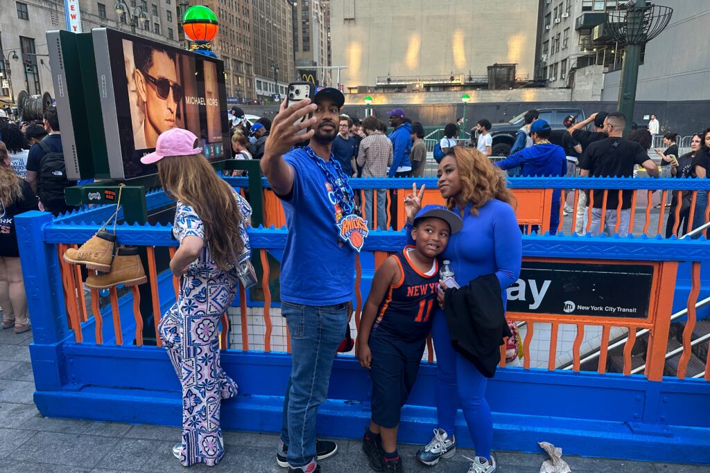 New York Knicks fans pose at a subway entrance in New York decorated in team colors as the Knicks play the San Antonio Spurs in Game 1 of the NBA Finals basketball series on Wednesday, June 3, 2026. Photo: Ted Shaffrey/AP