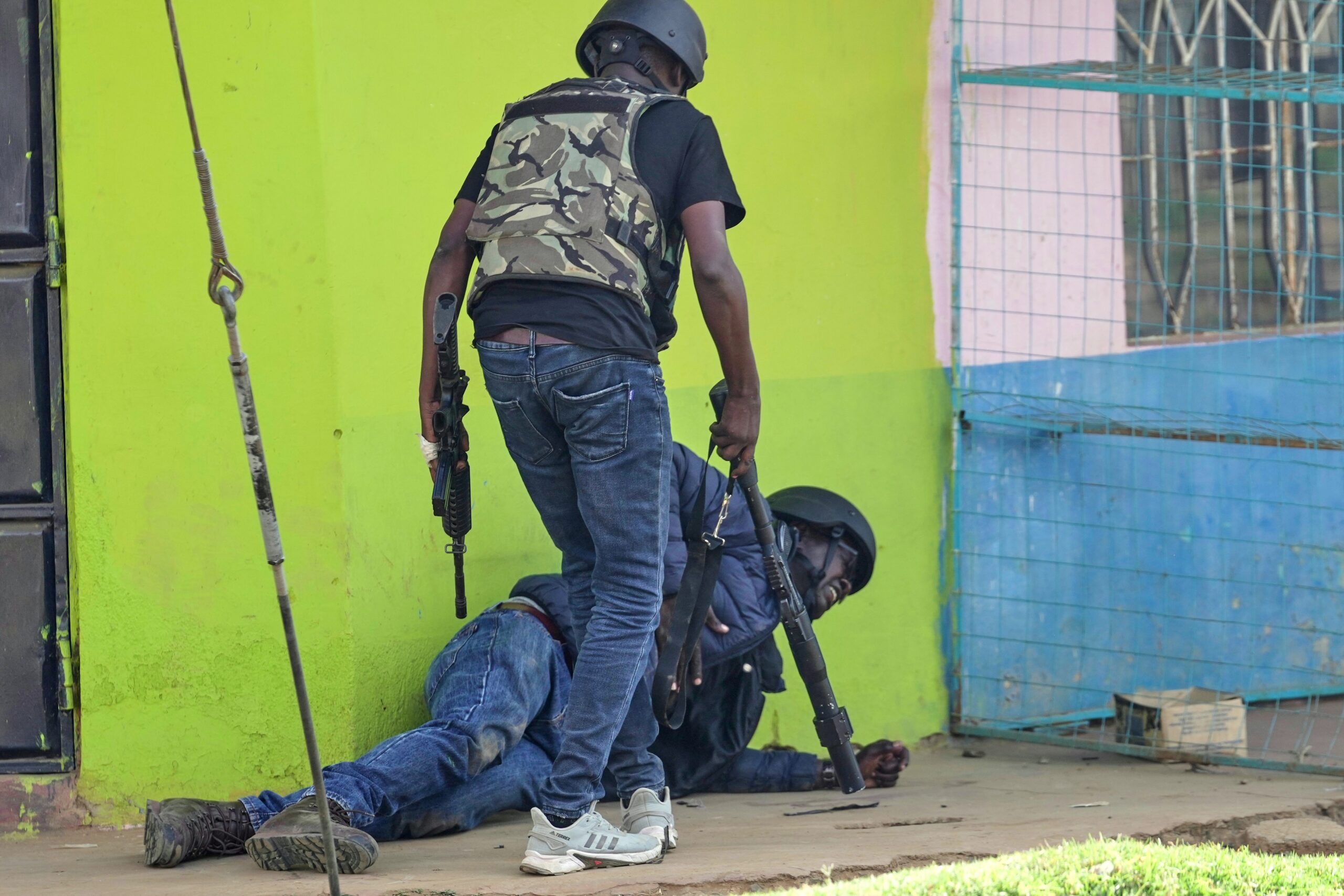 A plain clothes police officer helps a colleague who was struck by a stone thrown by protesters during a demonstration against a proposed U.S. Ebola quarantine center at Laikipia Air Base in Nanyuki, Kenya, Tuesday, June 9, 2026. Photo: Brian Inganga/AP