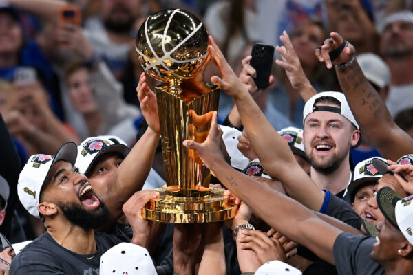 The New York Knicks celebrate with the Larry O'Brien Championship Trophy after defeating the San Antonio Spurs in Game 5 of the NBA Finals basketball series, Saturday, June 13, 2026, in San Antonio. (AP Photo/Darren Abate)