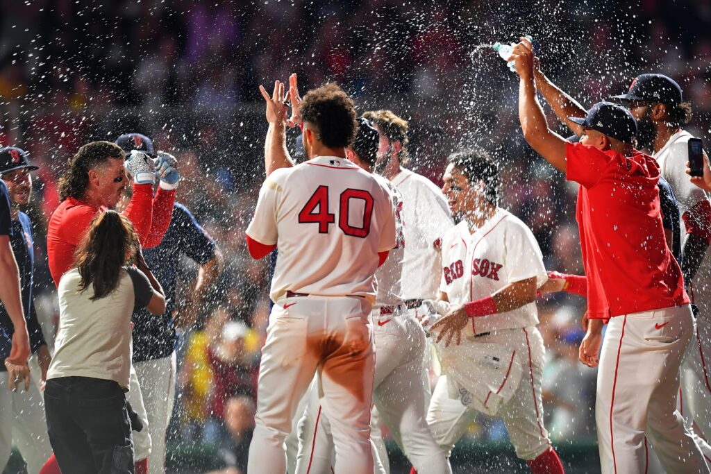 Boston Red Sox's Jarren Duran, left, celebrates with teammates after hitting a walk-off one-run single in the tenth inning of a baseball game to win against the New York Yankees, Sunday, June 28, 2026, in Boston. (AP Photo/Steven Senne)