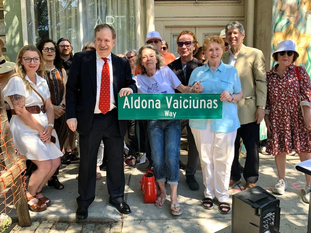 Holding the “Aldona Vaiciunas Way” street sign, from left: Michael Hartig, Linda McAllister and Assemblymember Jo Anne Simon. Photo: Mary Frost/Brooklyn Eagle