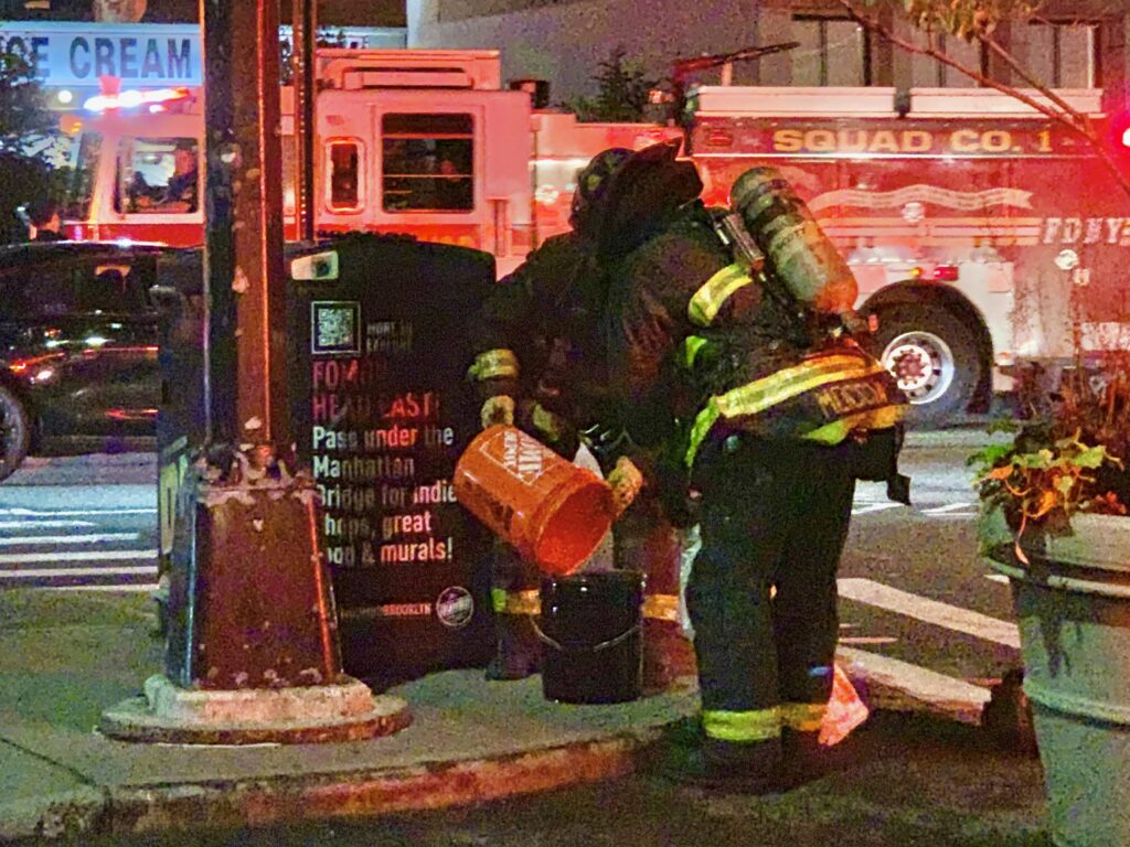 After an NYPD drone crashed in DUMBO last week, firefighters extinguished its smoking battery. Photo: Mary Frost/Brooklyn Eagle