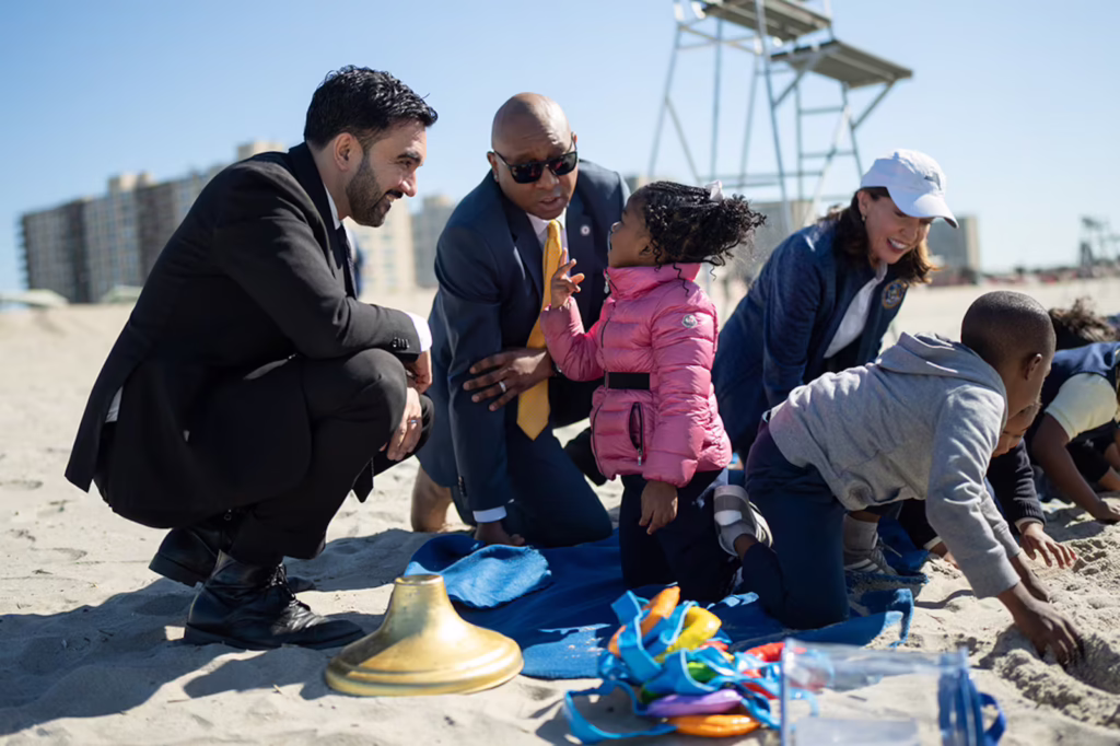 Mayor Zohran Mamdani speaks to a toddler at Rockaway Beach in Queens on Tuesday, June 2. Applications for the city's free 2-K program opened Tuesday. (Michael Appleton / Mayoral Photography Office)