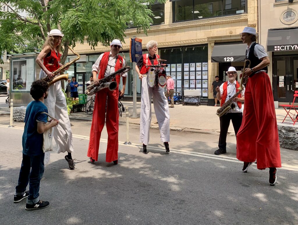 Eye-catching and toe-tapping: the Shinbone Alley Stilt Band brought joyful energy to Montague Street. Photo: Mary Frost/Brooklyn Eagle