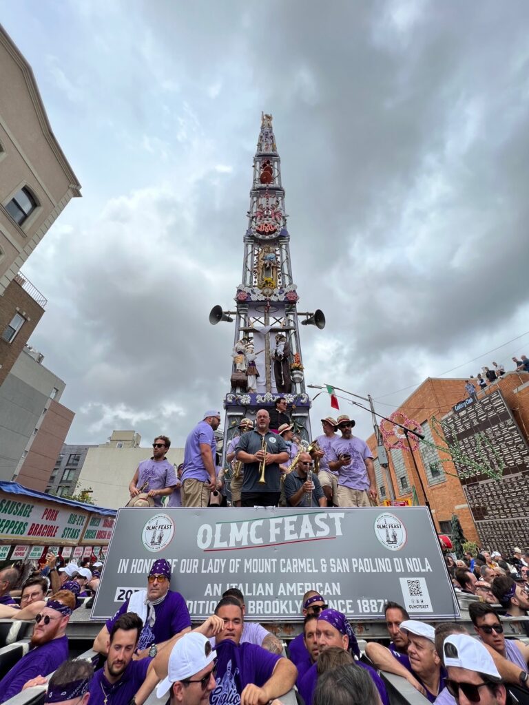 The Giglio tower stands about 80 feet tall and weighs four tons. The men of the community have a well-honed system in place for lifting the entire structure and dancing for hours around the neighborhood with it. Photo: John Quaglione