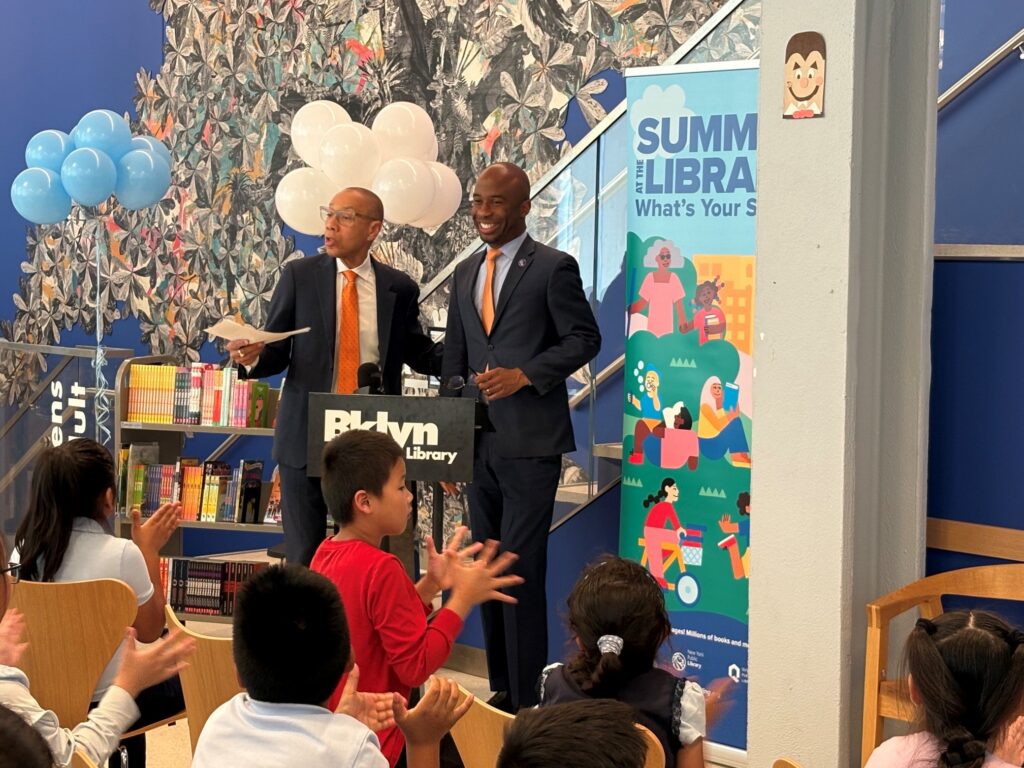 At the Sunset Park Library on Tuesday, Queens Public Library President & CEO Dennis Walcott, left, joined New York City Public Schools Chancellor Kamar Samuels to kick off the citywide “Summer at the Library” reading program. Photo: BPL