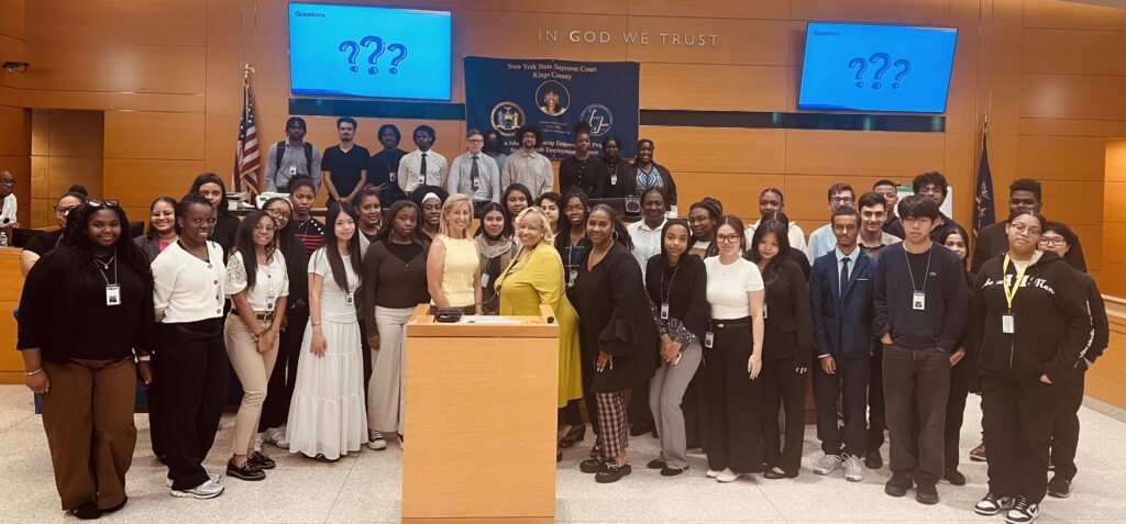 Debra Sinodinos, Hon. Deborah Dowling and Nicole B. Smith alongside interns. Photo: Wayne Daren Schneiderman/Brooklyn Eagle