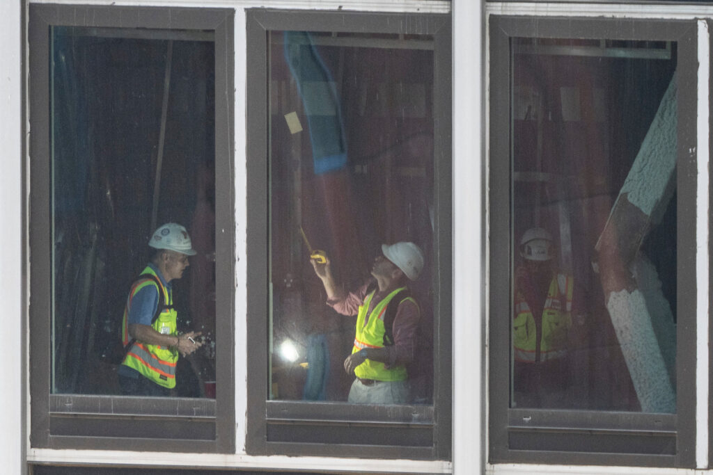People inspect a buckled support beam inside 235 East 42nd Street, Wednesday, July 8, 2026, in New York. (AP Photo/Yuki Iwamura)