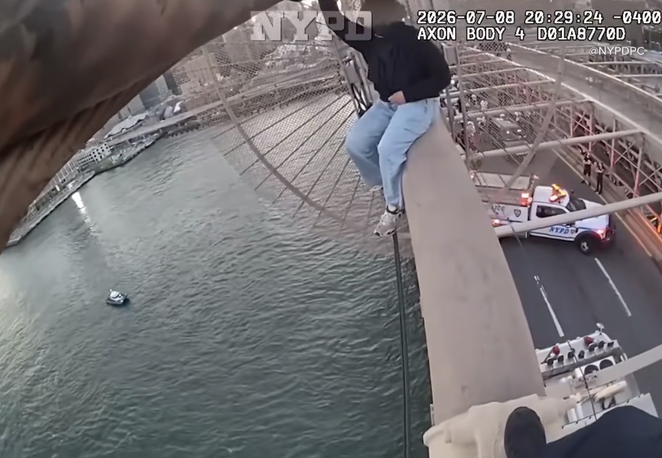 Body cam image shows police rescue a distressed woman from the Brooklyn Bridge on Wednesday. Photo: NYPD