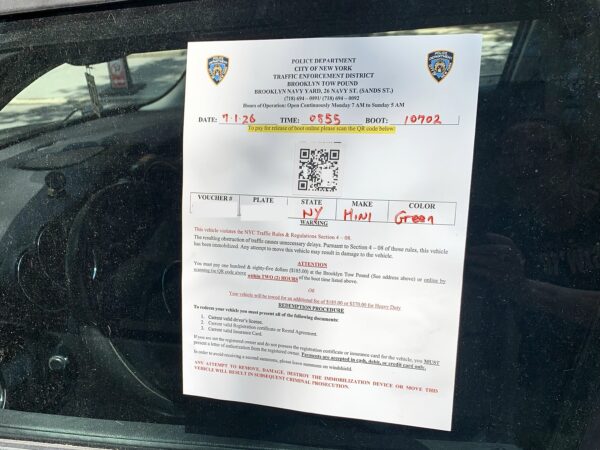 This the easier-to-remove sticker used when the NYPD “boots” an illegally-parked vehicle. This sticker was seen on a car in Brooklyn Heights on Wednesday. Photo: Mary Frost/Brooklyn Eagle
